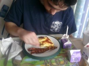 His first taste of bacon and eggs!